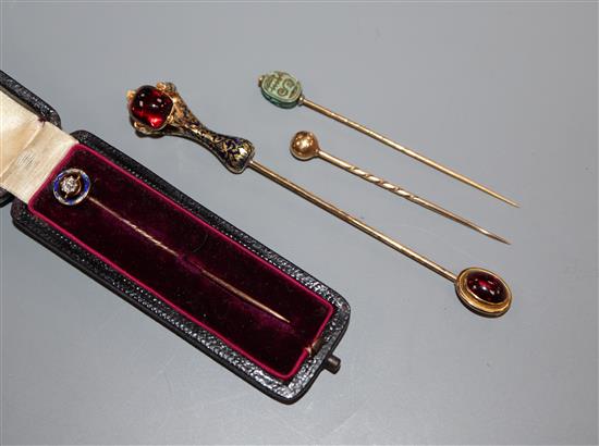An Edwardian diamond and blue enamel set stick pin and three other stick pins including scarab and cabochon set jabot pin.